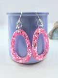 Pink Glittery sparkling dangly resin oval hoop earrings in silver, modern, statement, funky jewelry