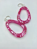 Pink Glittery sparkling dangly resin oval hoop earrings in silver, modern, statement, funky jewelry