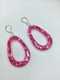 Pink Glittery sparkling dangly resin oval hoop earrings in silver, modern, statement, funky jewelry