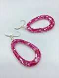 Pink Glittery sparkling dangly resin oval hoop earrings in silver, modern, statement, funky jewelry