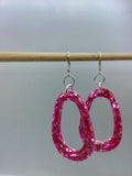 Pink Glittery sparkling dangly resin oval hoop earrings in silver, modern, statement, funky jewelry