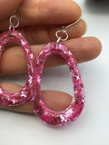 Pink Glittery sparkling dangly resin oval hoop earrings in silver, modern, statement, funky jewelry
