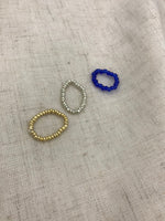 Trio beaded stack rings in greenery, cobalt blue, cherry red and one gold and one silver