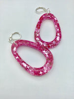 Pink Glittery sparkling dangly resin oval hoop earrings in silver, modern, statement, funky jewelry
